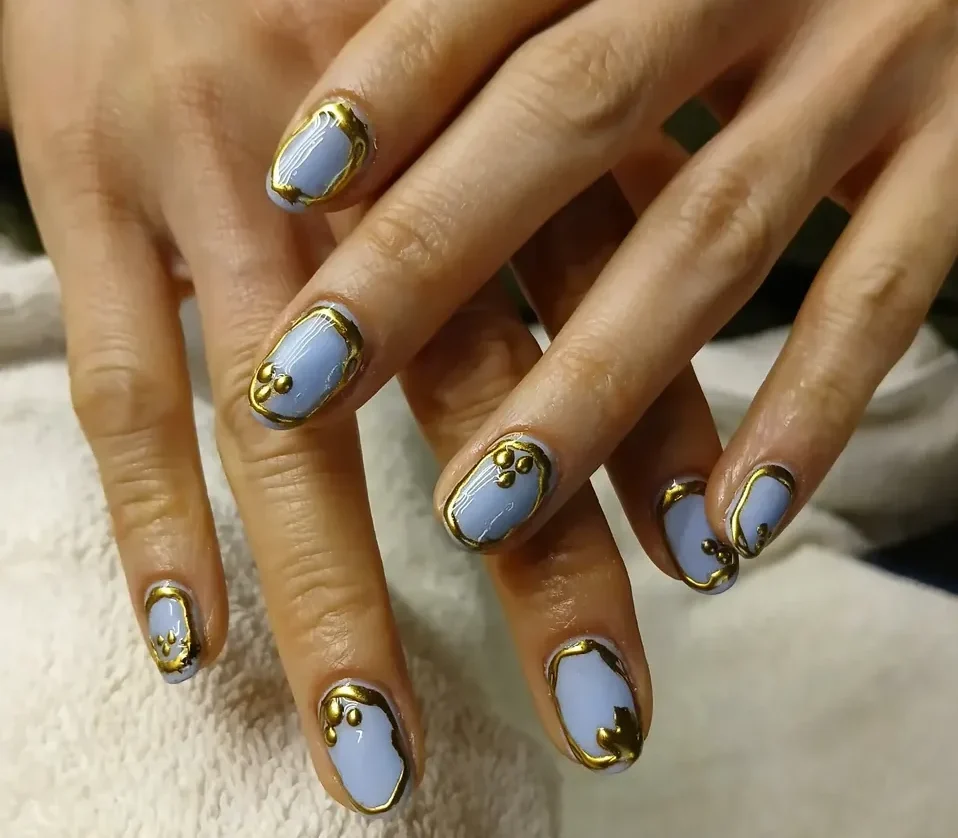 Blue and gold manicure nail art at Subina’s Nails Palace in Jhamsikhel