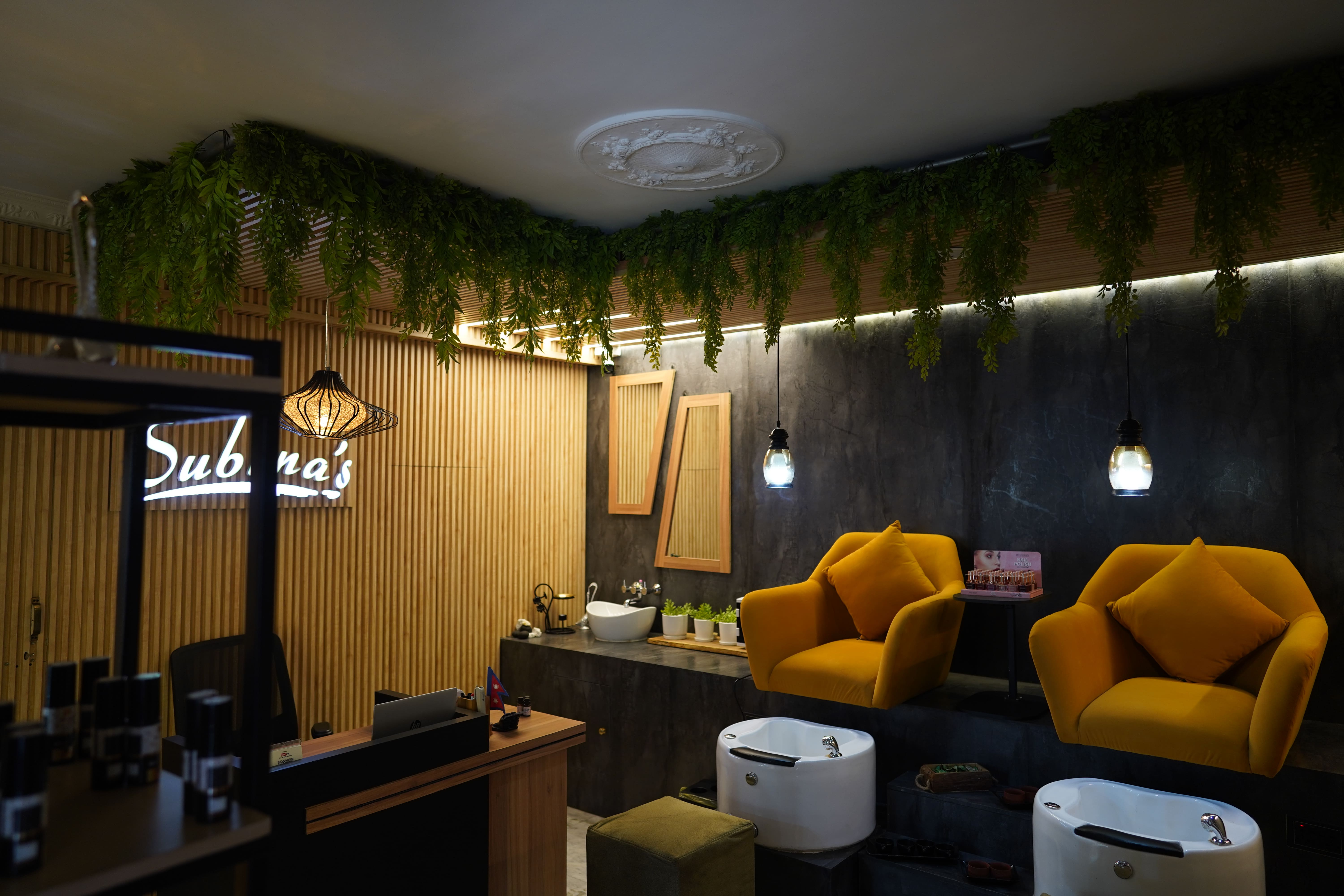 Modern manicure and pedicure area at Subina's Nails Palace with comfortable yellow chairs and elegant interior.