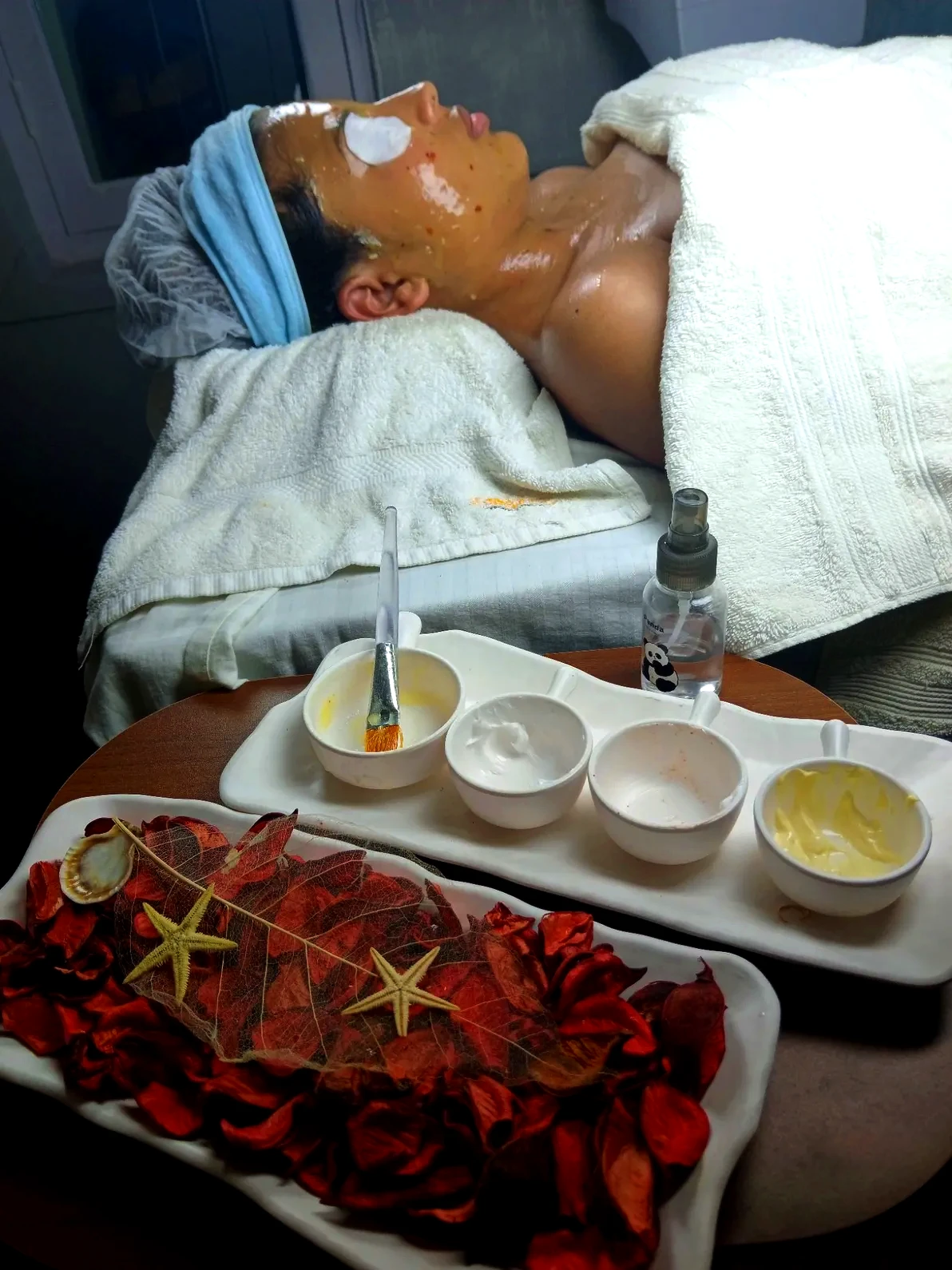 Client enjoying a rejuvenating facial treatment with professional skincare products and relaxing spa ambiance