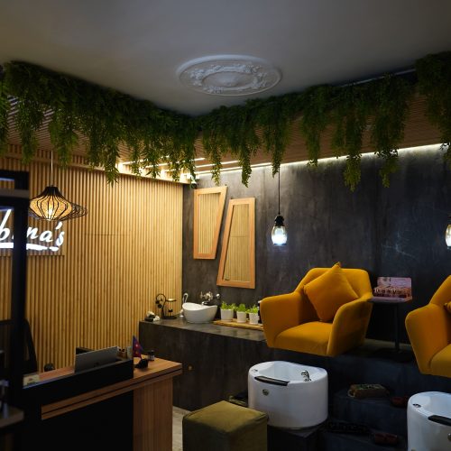 Modern manicure and pedicure area at Subina's Nails Palace with comfortable yellow chairs and elegant interior.