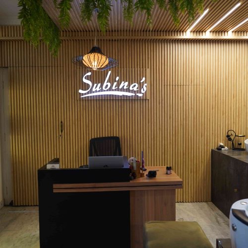 Subina's Nails Palace interior showcasing the modern nail salon reception area with elegant wooden design and relaxing beauty space
