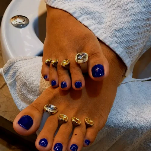 Professional pedicure with glossy royal blue toenail polish at a premium nail salon in Jhamsikhel