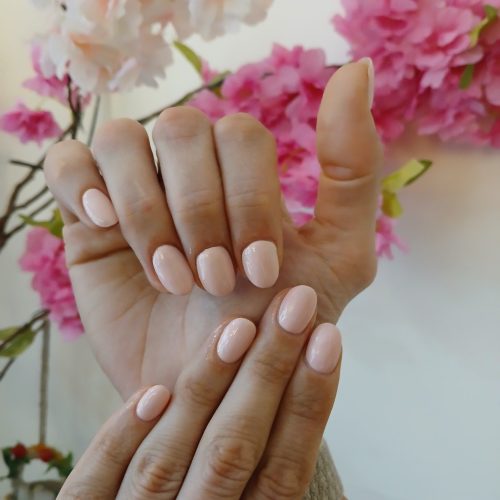 Nude pink manicure with glossy finish at a nail salon in Jhamsikhel